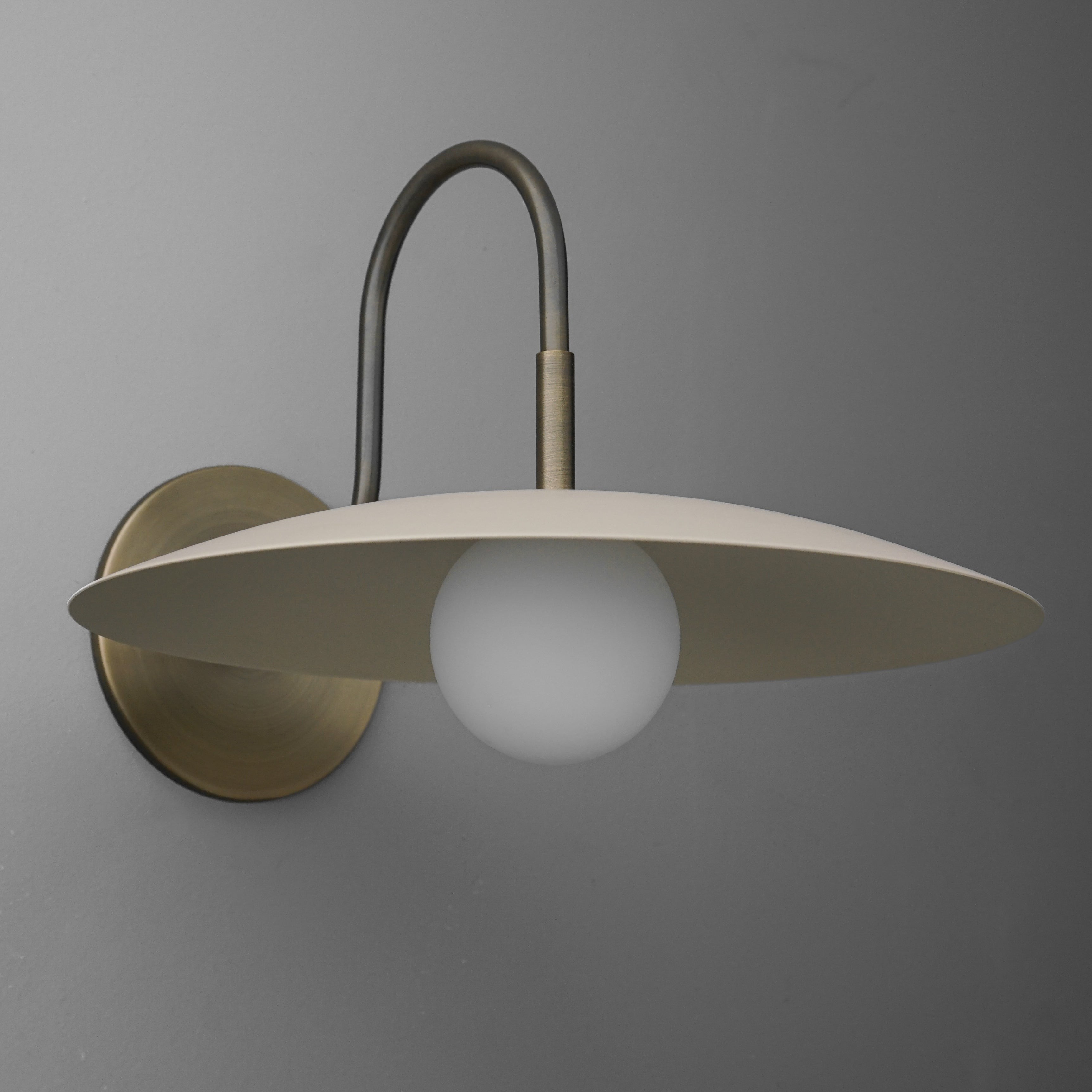 Curva Metal Modern Wall Sconce - Antique Brass Arm with Cream Disc Shade T409