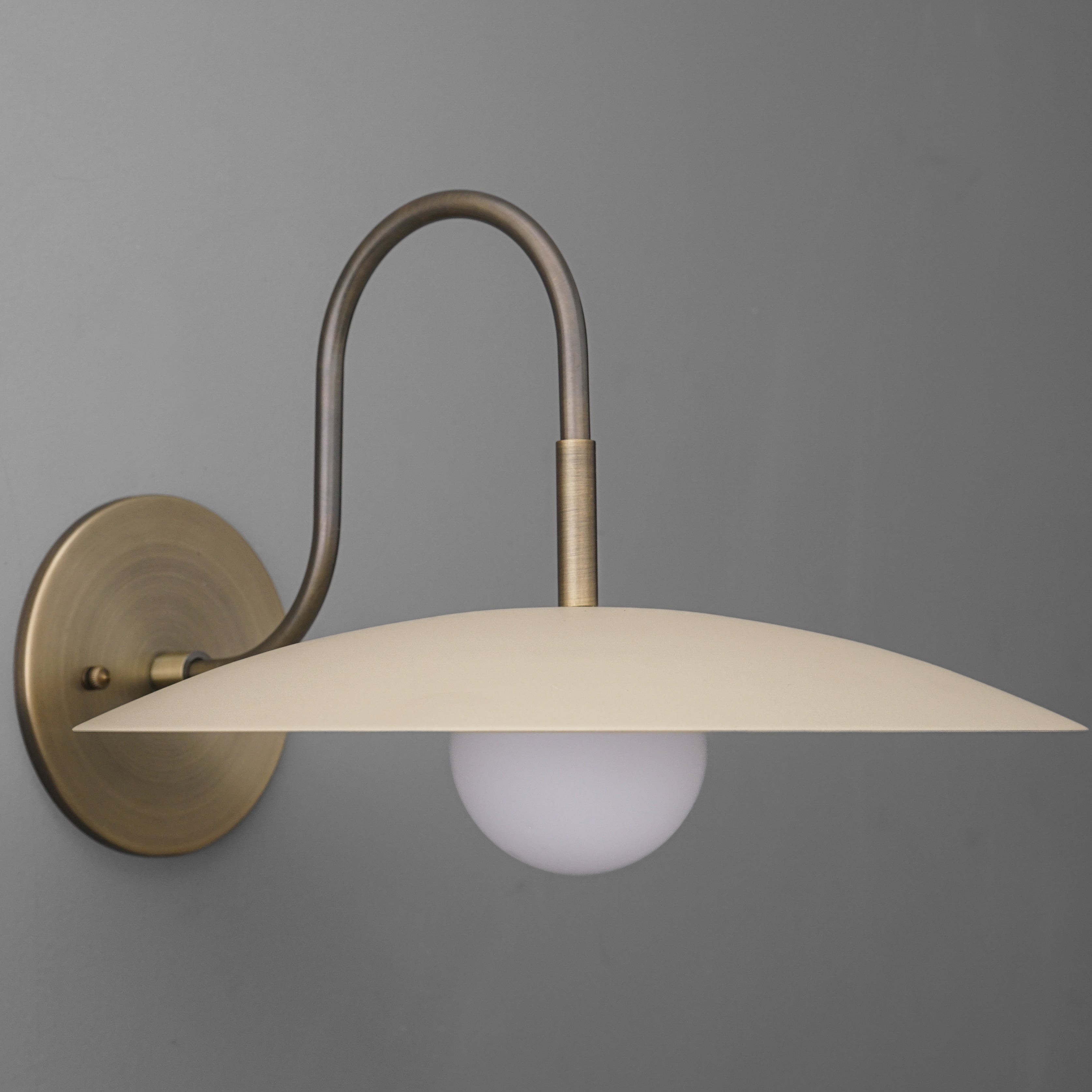 Curva Metal Modern Wall Sconce - Antique Brass Arm with Cream Disc Shade T409
