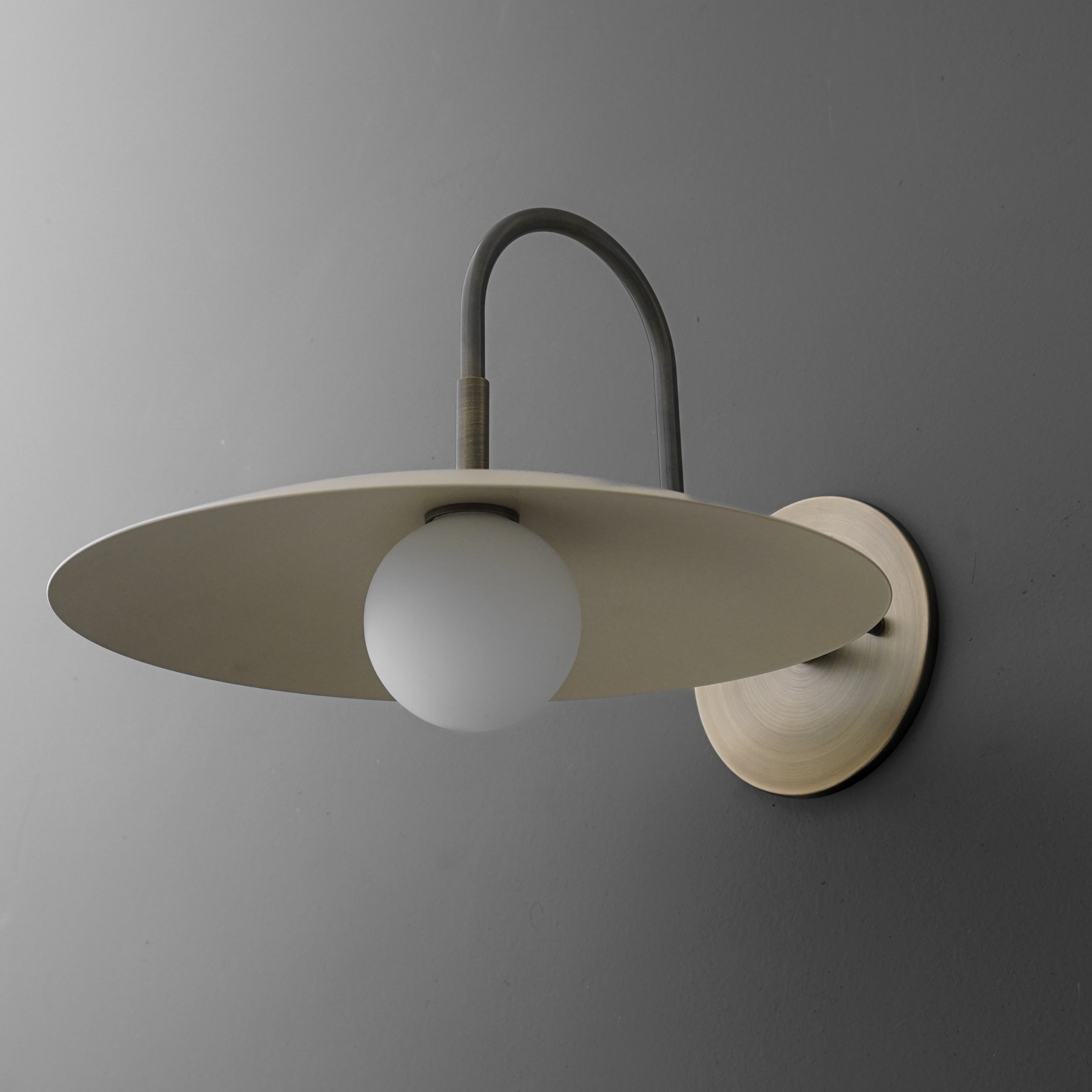 Curva Metal Modern Wall Sconce - Antique Brass Arm with Cream Disc Shade T409
