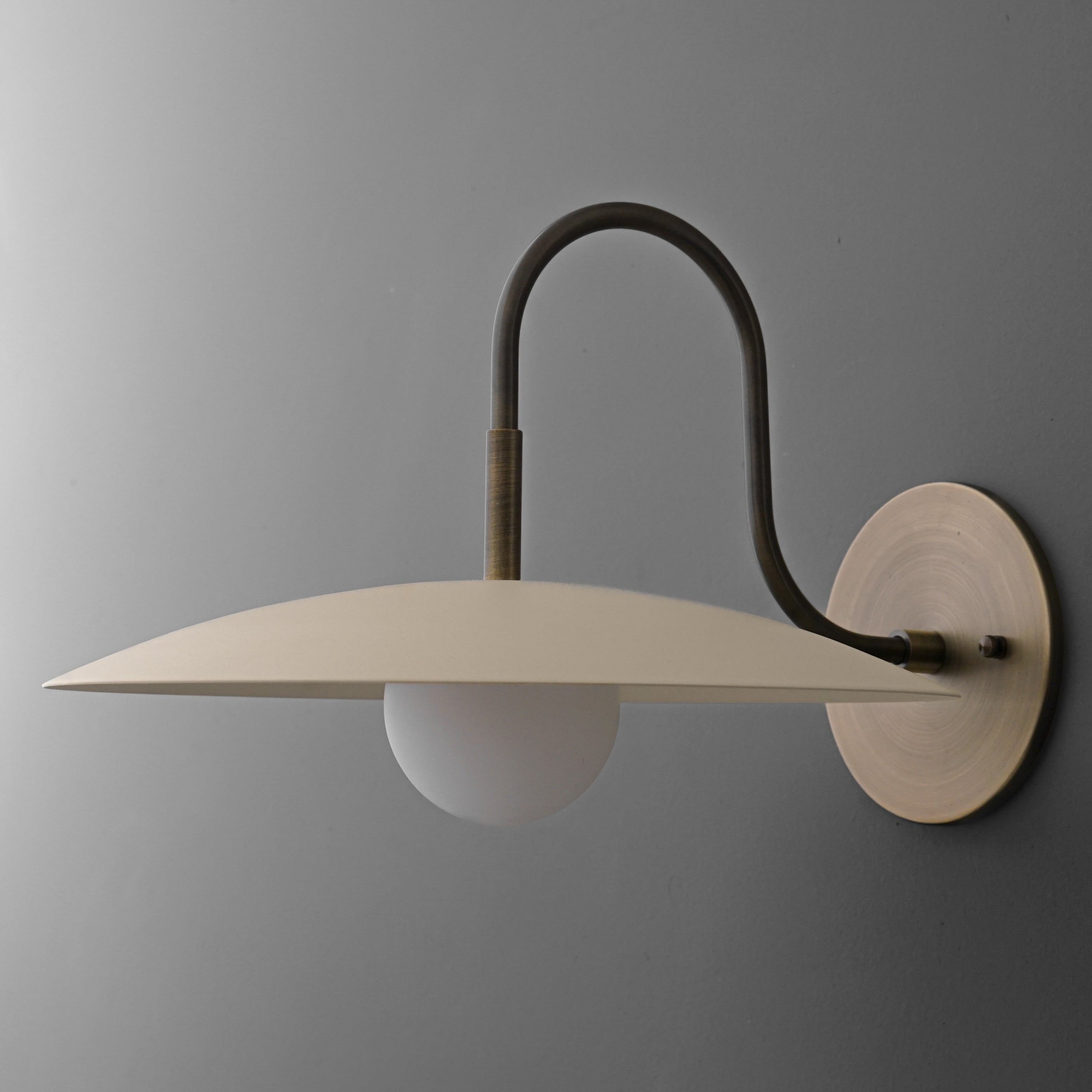 Curva Metal Modern Wall Sconce - Antique Brass Arm with Cream Disc Shade T409