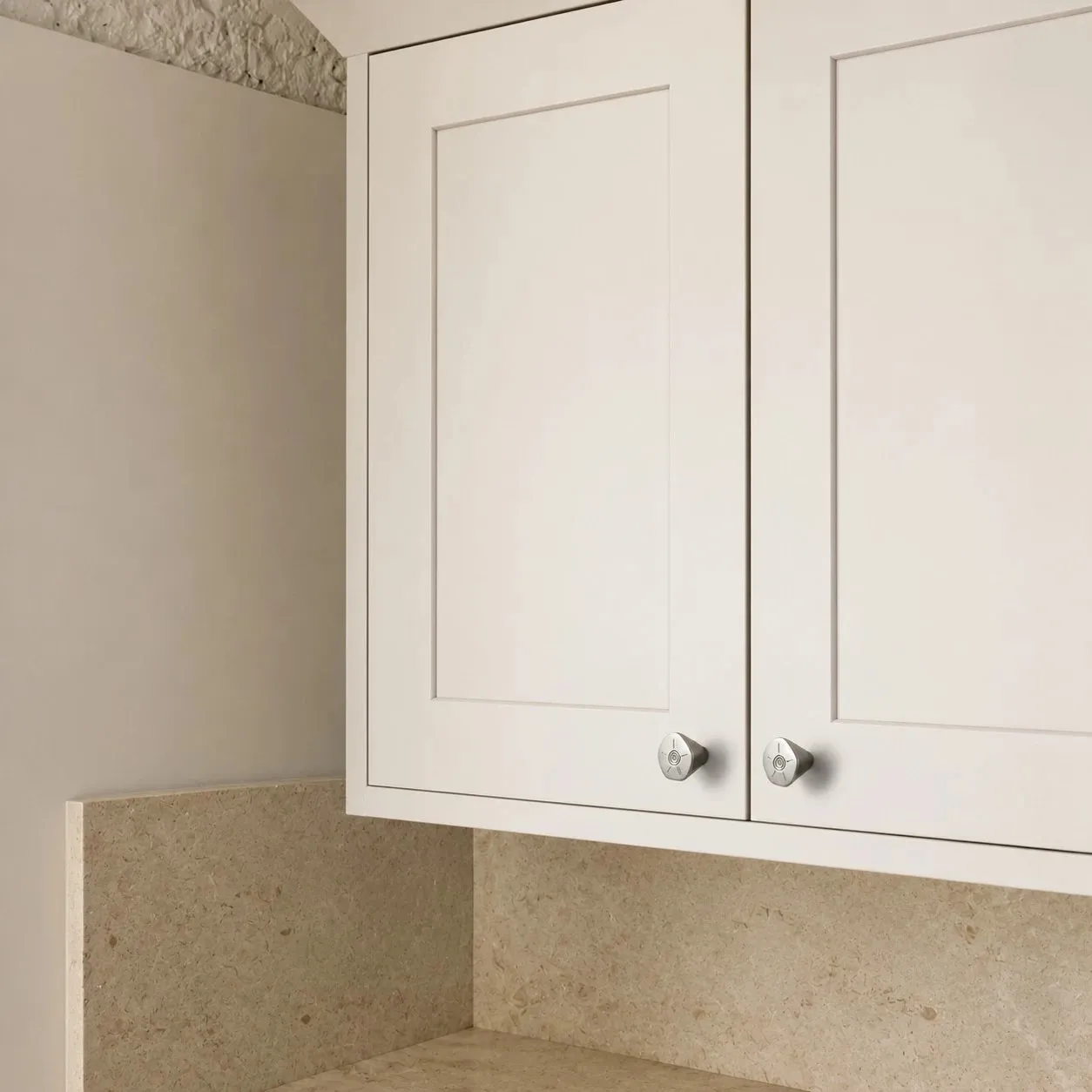 Titanium silver knobs on white cabinet doors