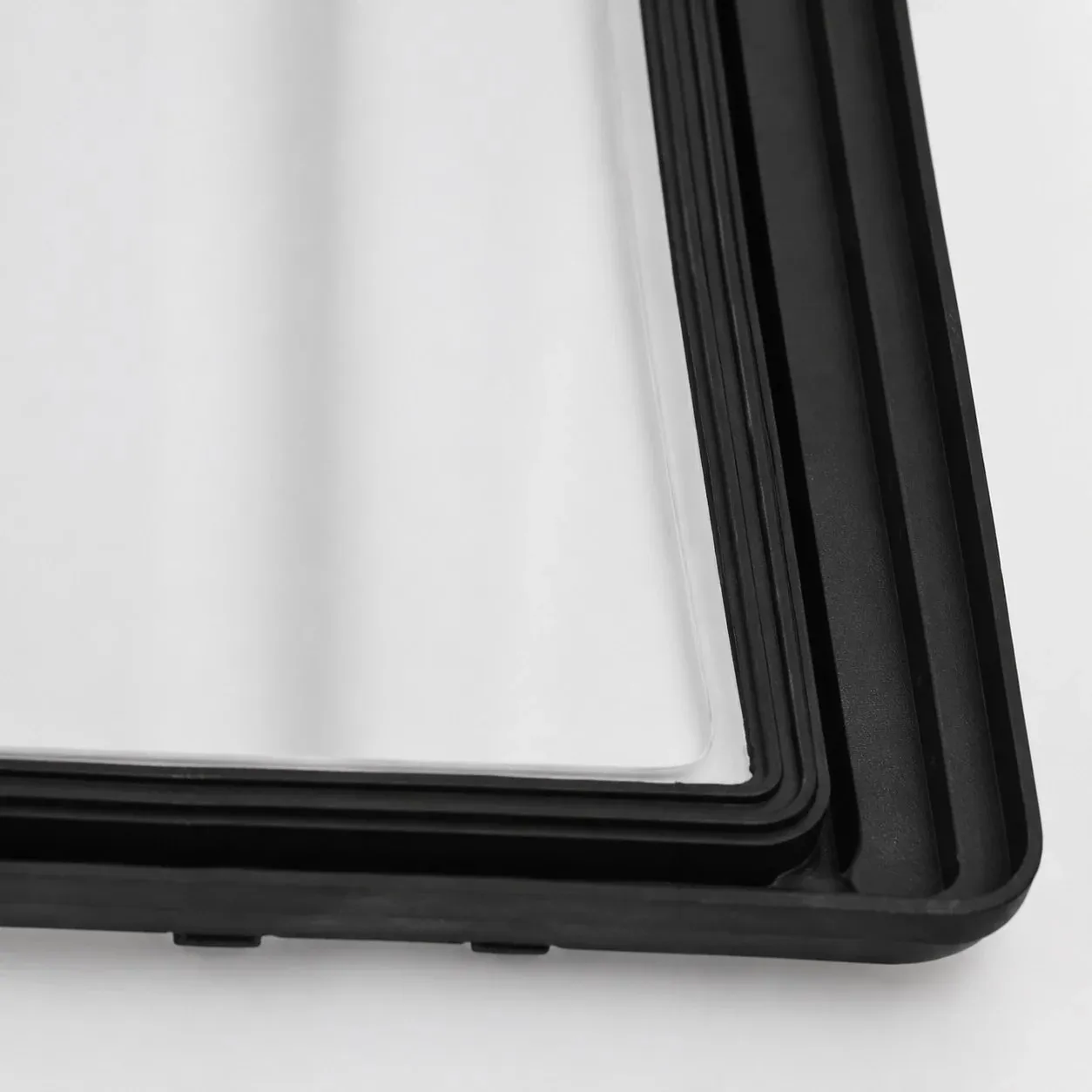 Close-up of black frame and white glass shade