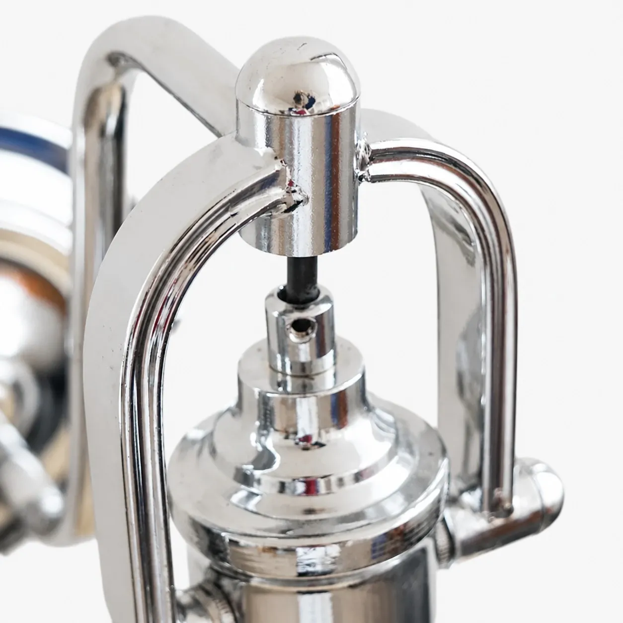 Chrome holder detail on Bauhaus glass wall sconce
