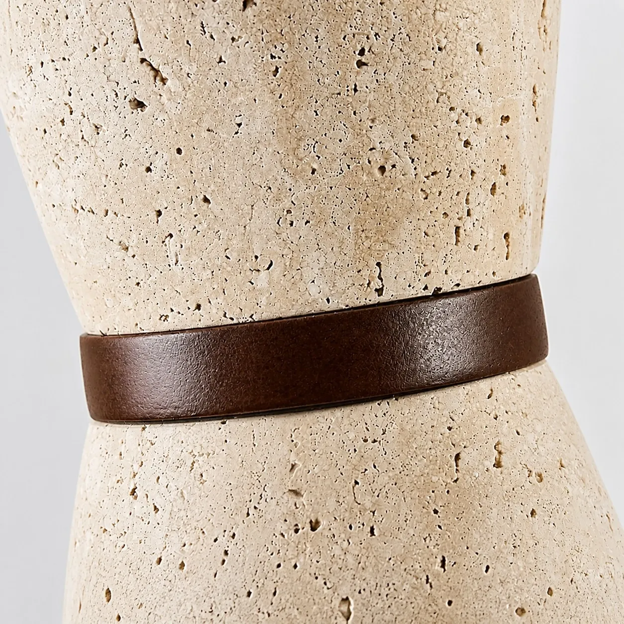 Close view of natural travertine texture and solid wood band