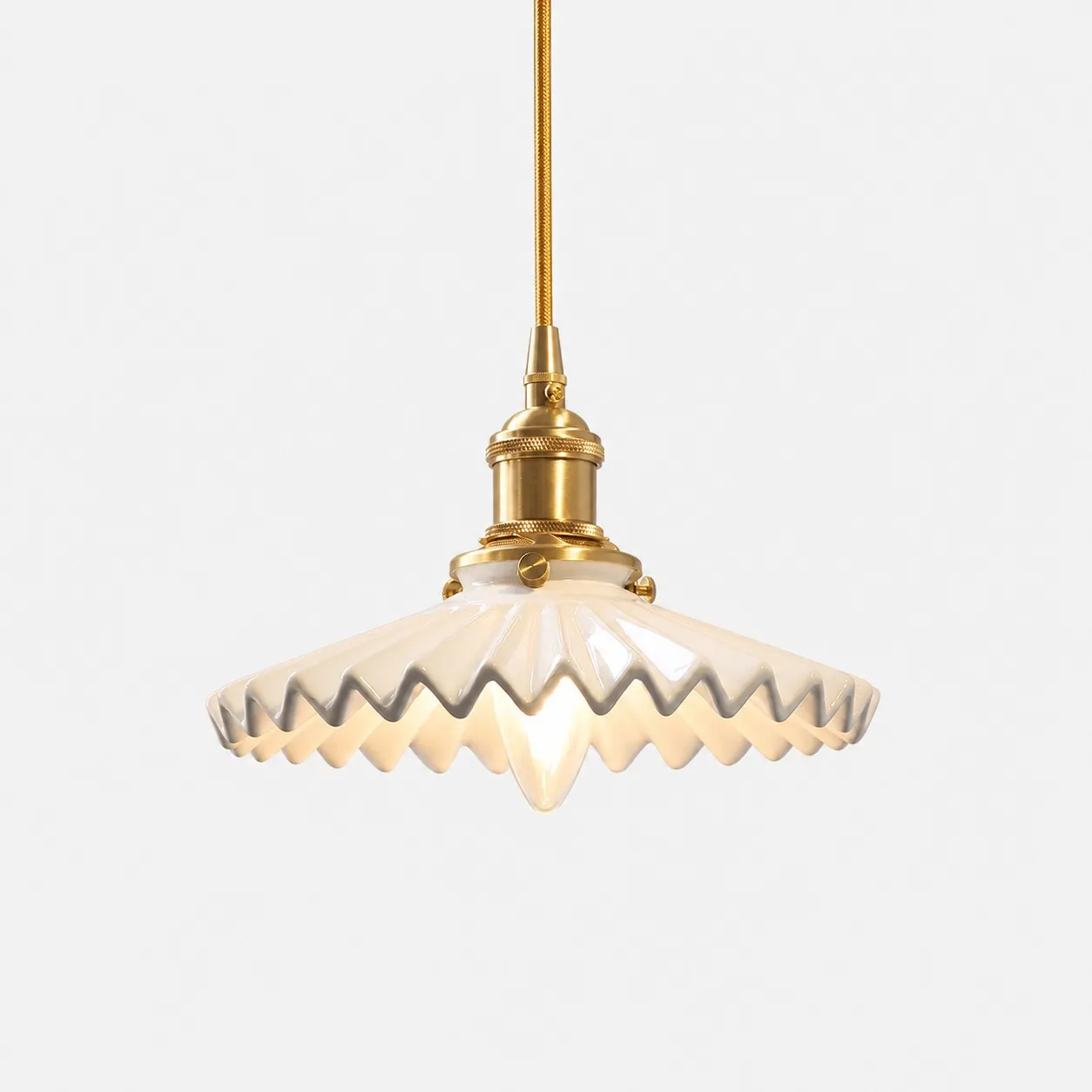White pleated ceramic pendant light with brass-finish base
