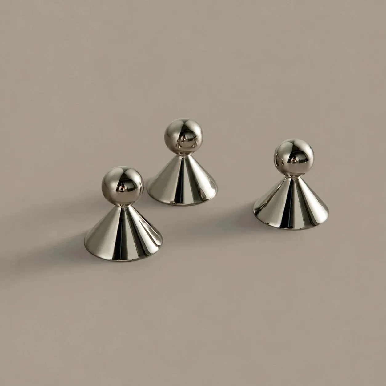 Sculptural brass cabinet knobs shown from several angles